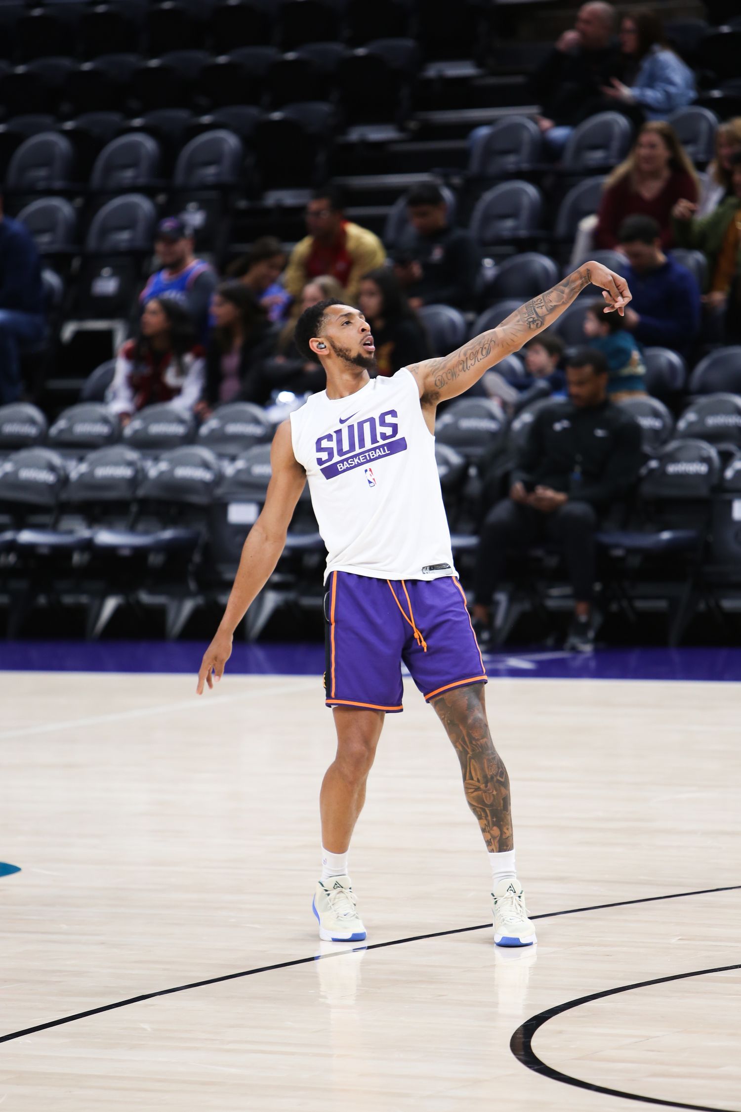Phoenix Suns player shooting during NBA pregame warmups on an empty court.