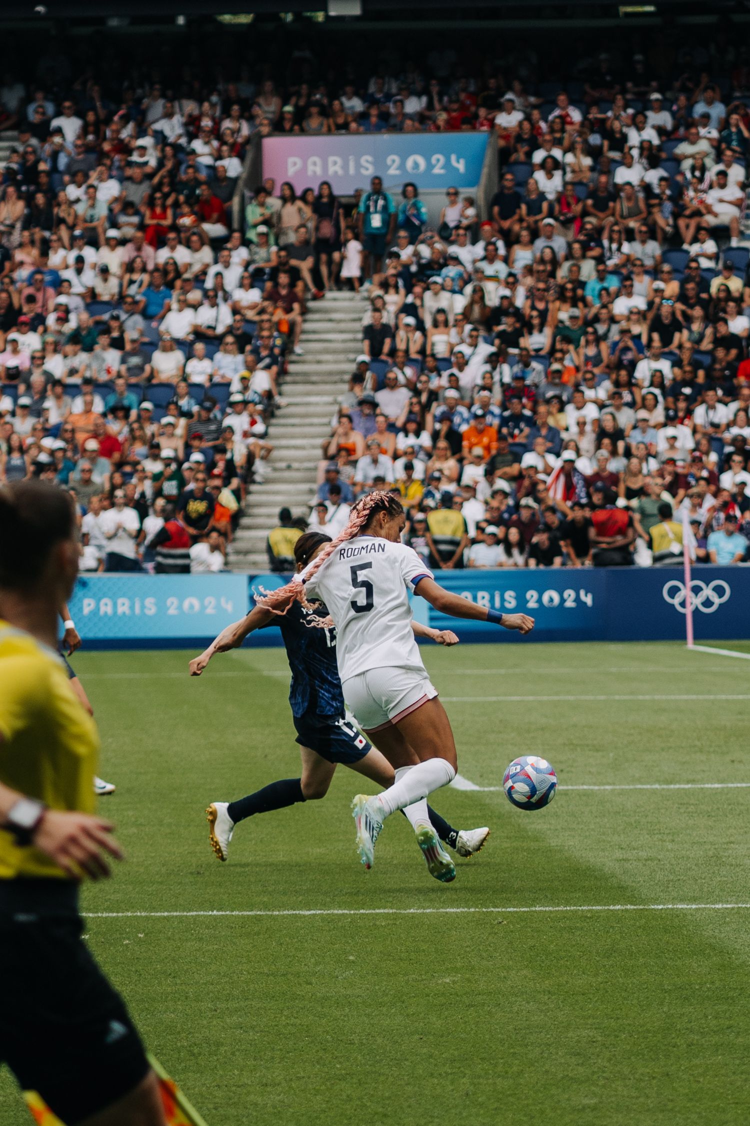 Two female soccer players battle for the ball during the Paris 2024 Olympic Games match.