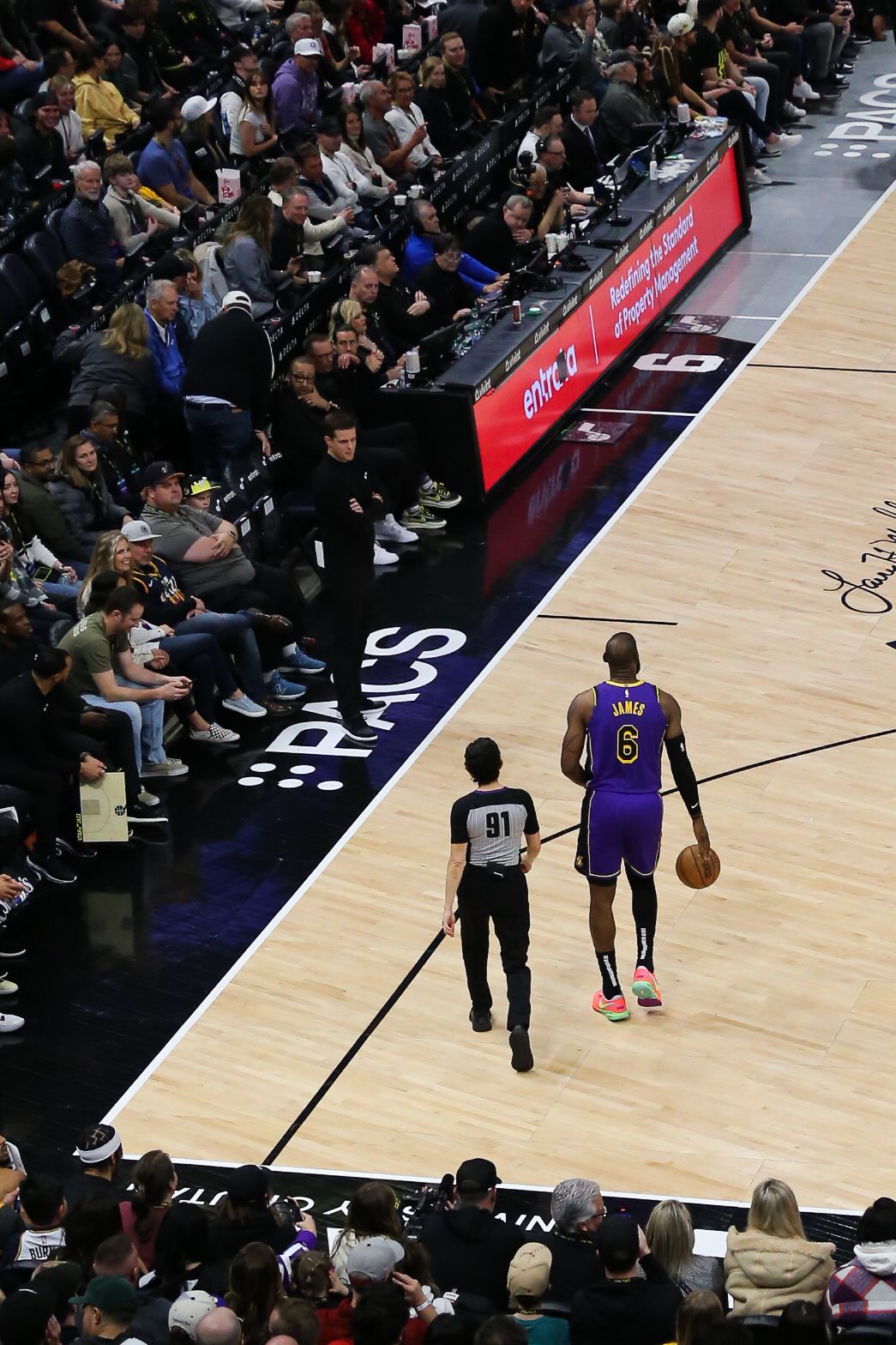 LeBron James #6 of the LA Lakers dribbling along the sideline during an NBA game.