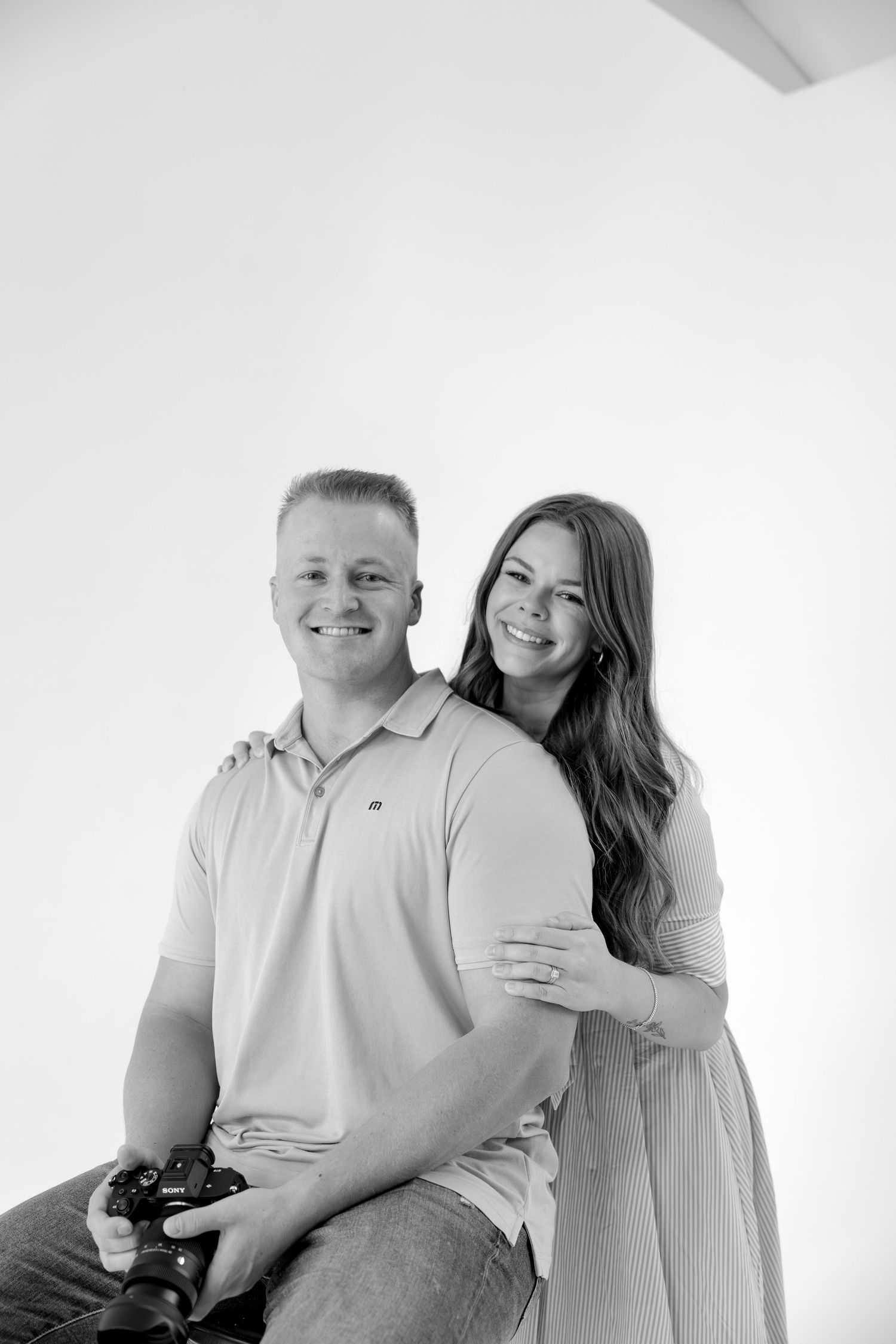 Casual studio portrait session in light casual wear against white backdrop.