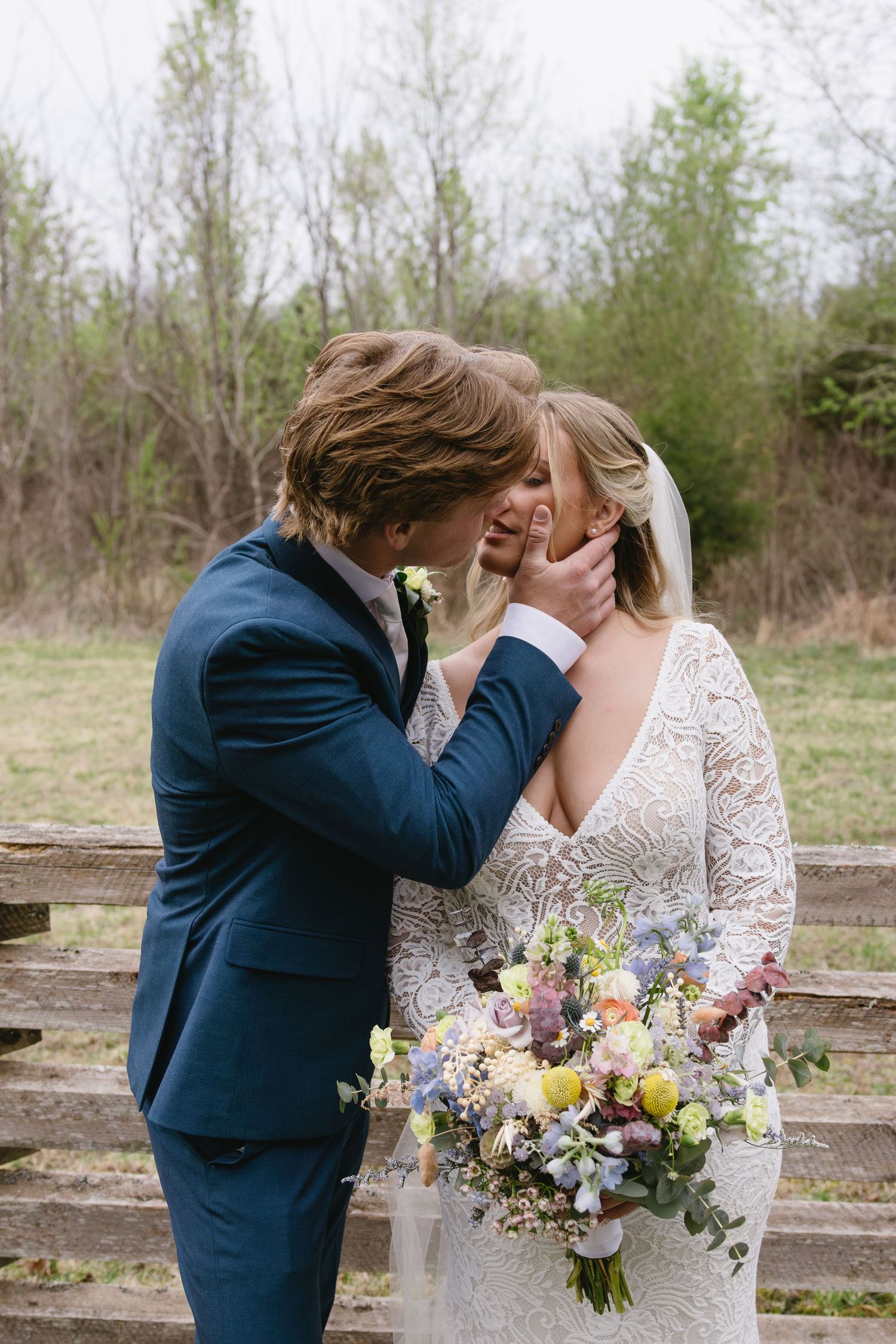 Outdoor wedding first look moment with colorful spring bouquet.