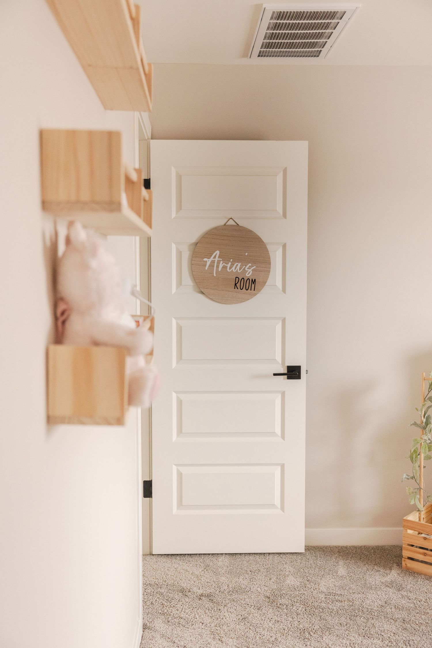 White paneled door with a round wooden 
