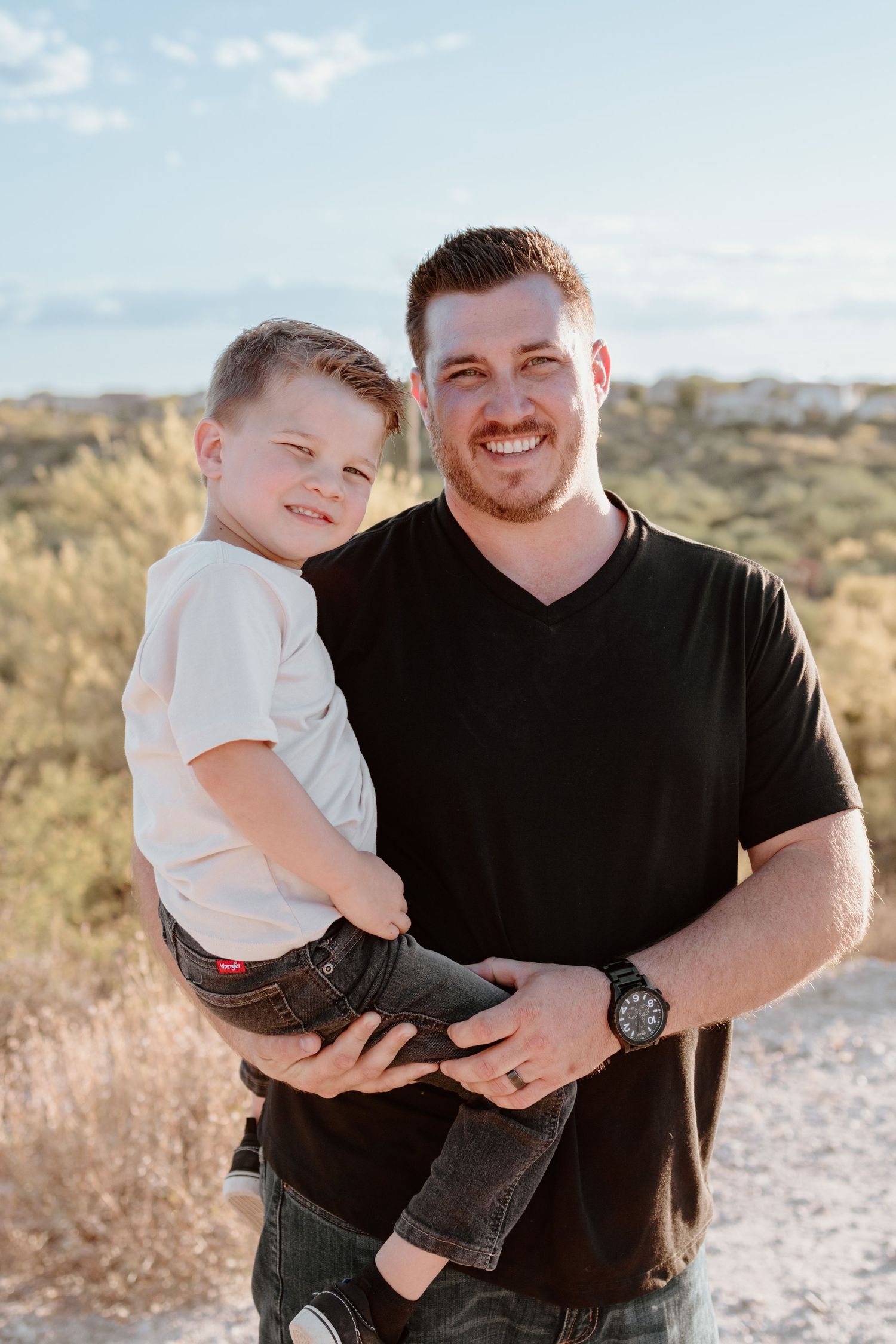 A series of three candid outdoor photos showing tender moments between a parent and child in a desert landscape.
