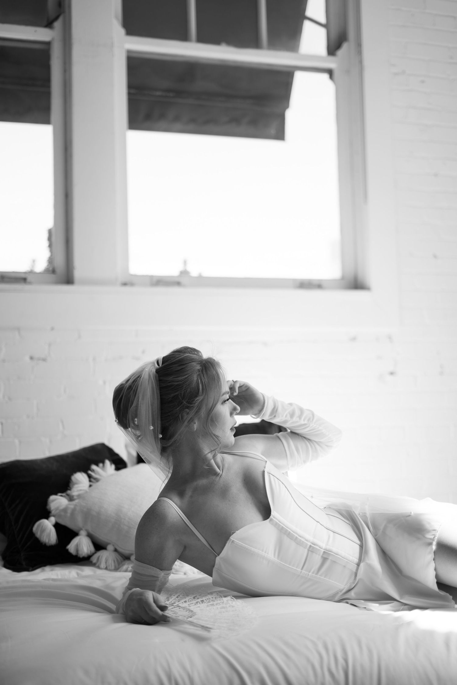 Artistic black and white boudoir photography series with soft natural window lighting.