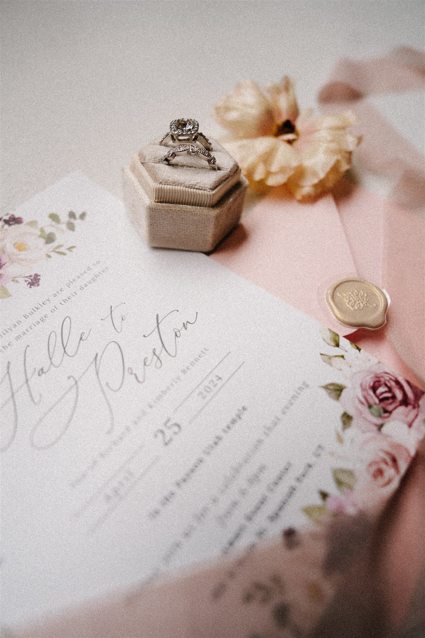 Wedding invitation suite with elegant calligraphy and delicate floral details.