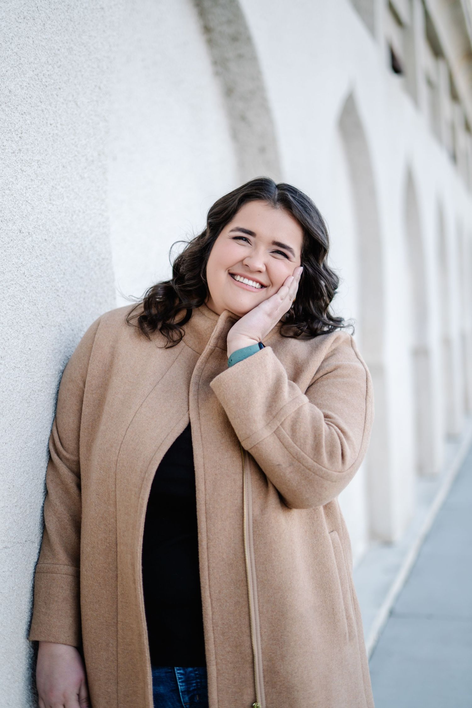 Portrait session against white columns featuring casual winter style.