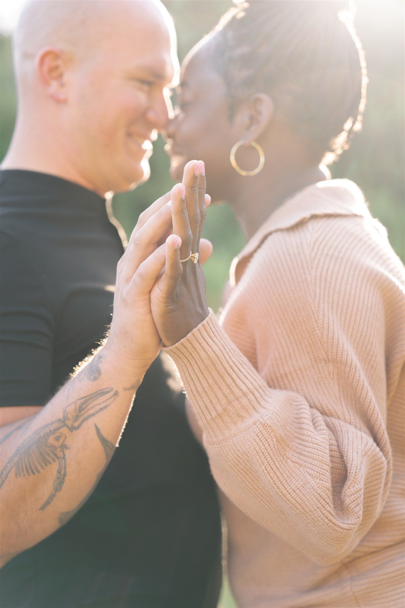 Intimate close-up portrait of a couple during a tender moment in soft natural lighting.