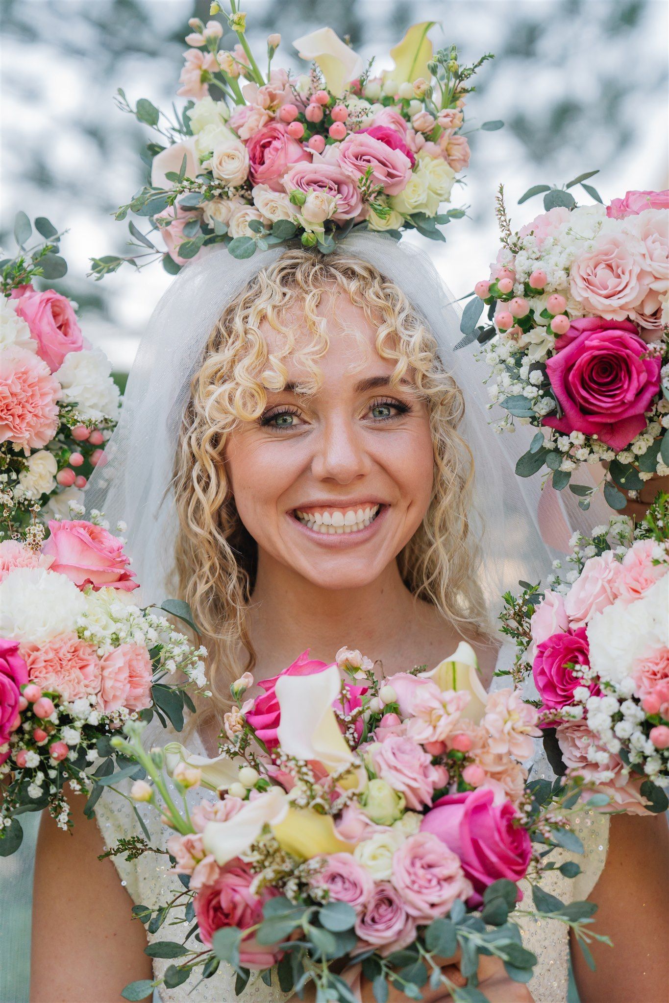 Close-up of floral arrangements featuring pink roses and delicate blooms.