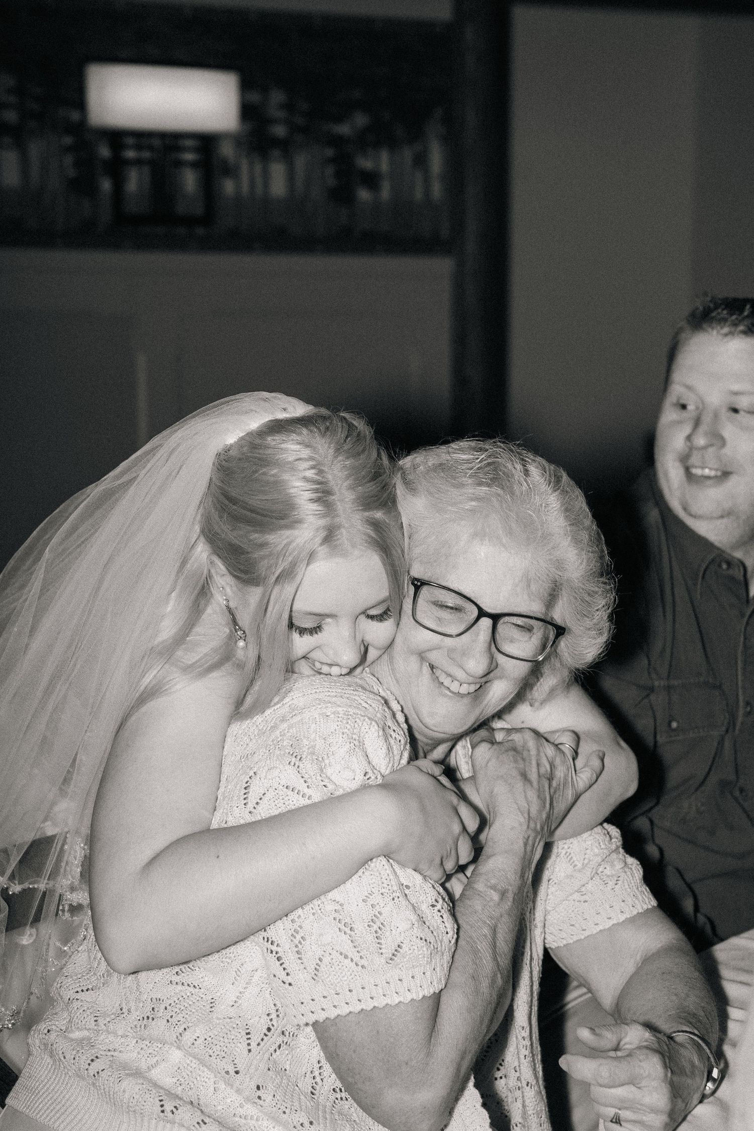 Black and white emotional moments captured during wedding reception celebrations.