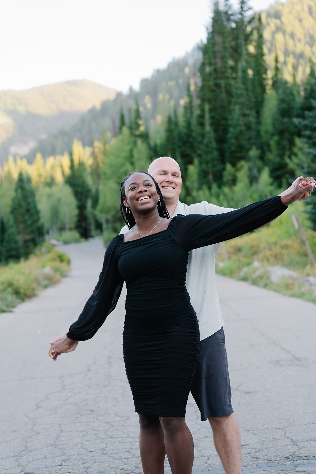 Dancing and joyful moments shared on a mountain path with scenic views.