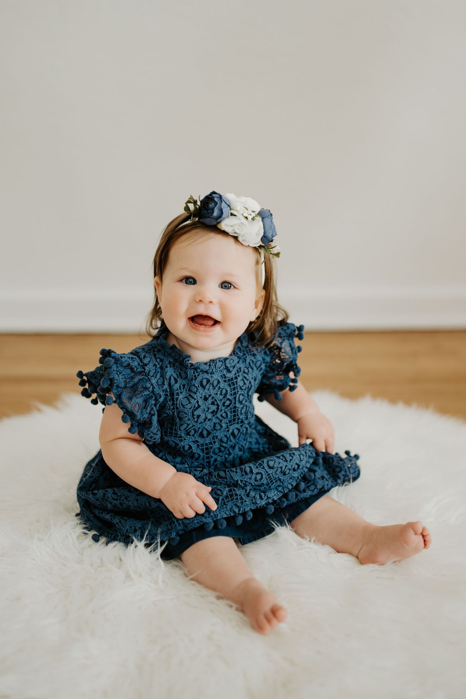 Studio photo of a 12 month old girl. Milestone Sessions are a great way to capture memories you don't want to forget.