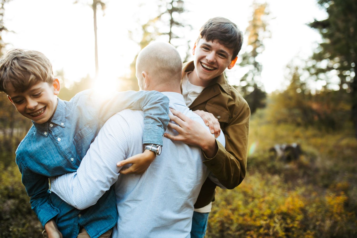 Father playing with his sons during a photoshoot in McCall