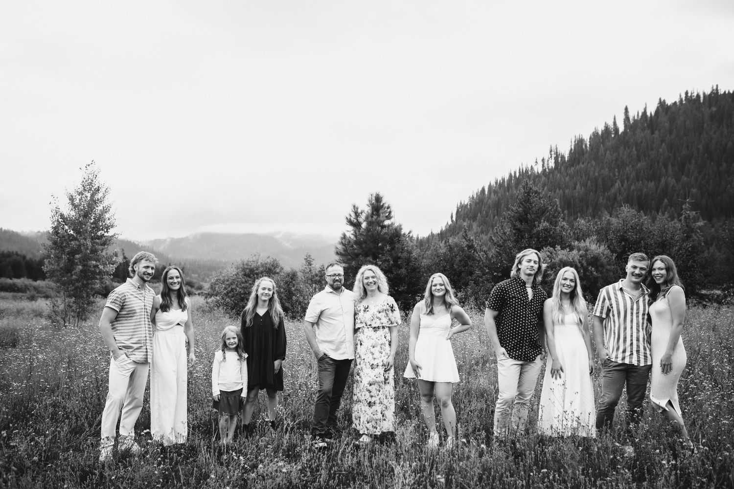Black and white image of family standing together for portraits in Cascade Idaho