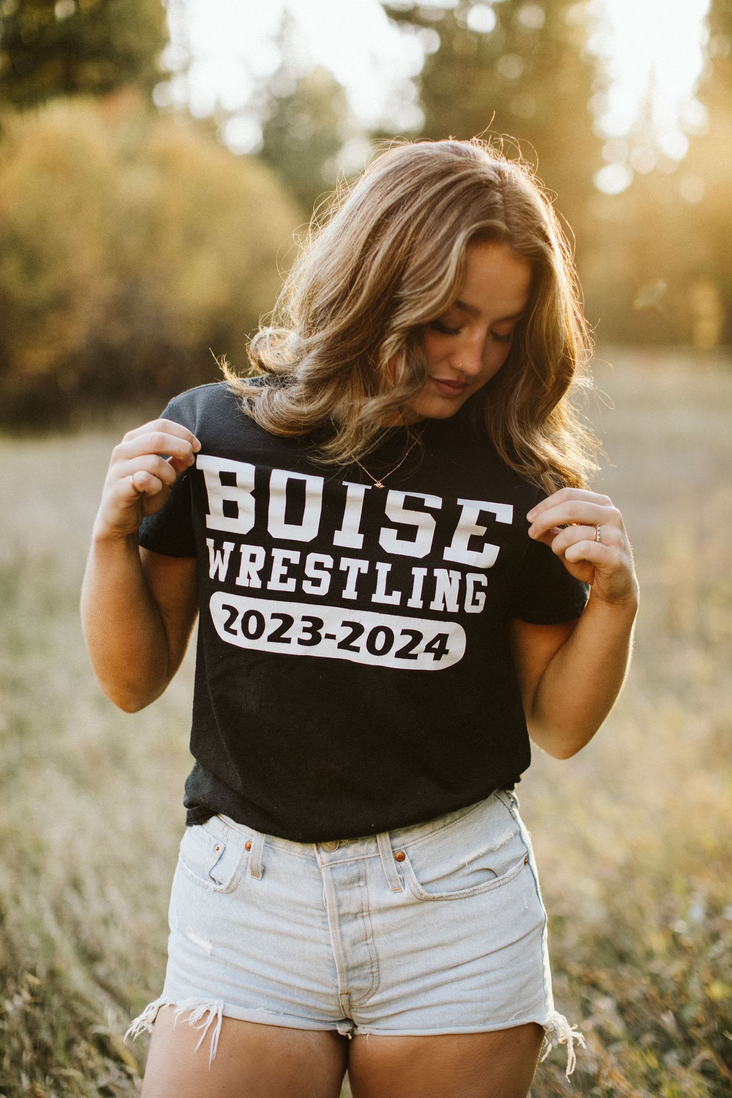 Young woman posing for her senior portraits at Robie Creek near Boise Idaho