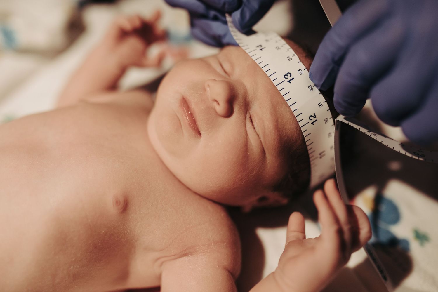 Photography of a newborn baby being weighed and measured in Boise