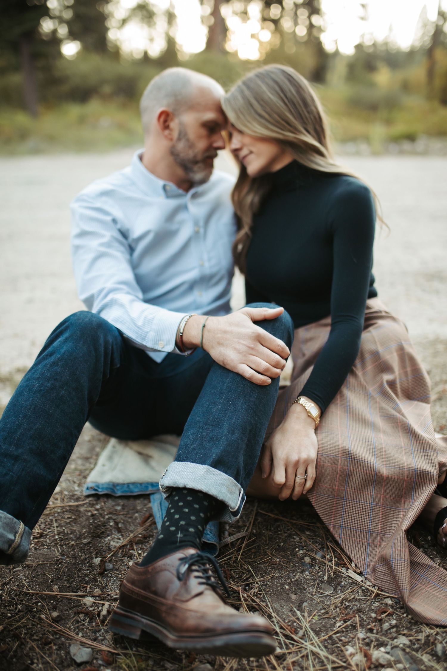 Husband and wife sitting together for family photos in McCAll