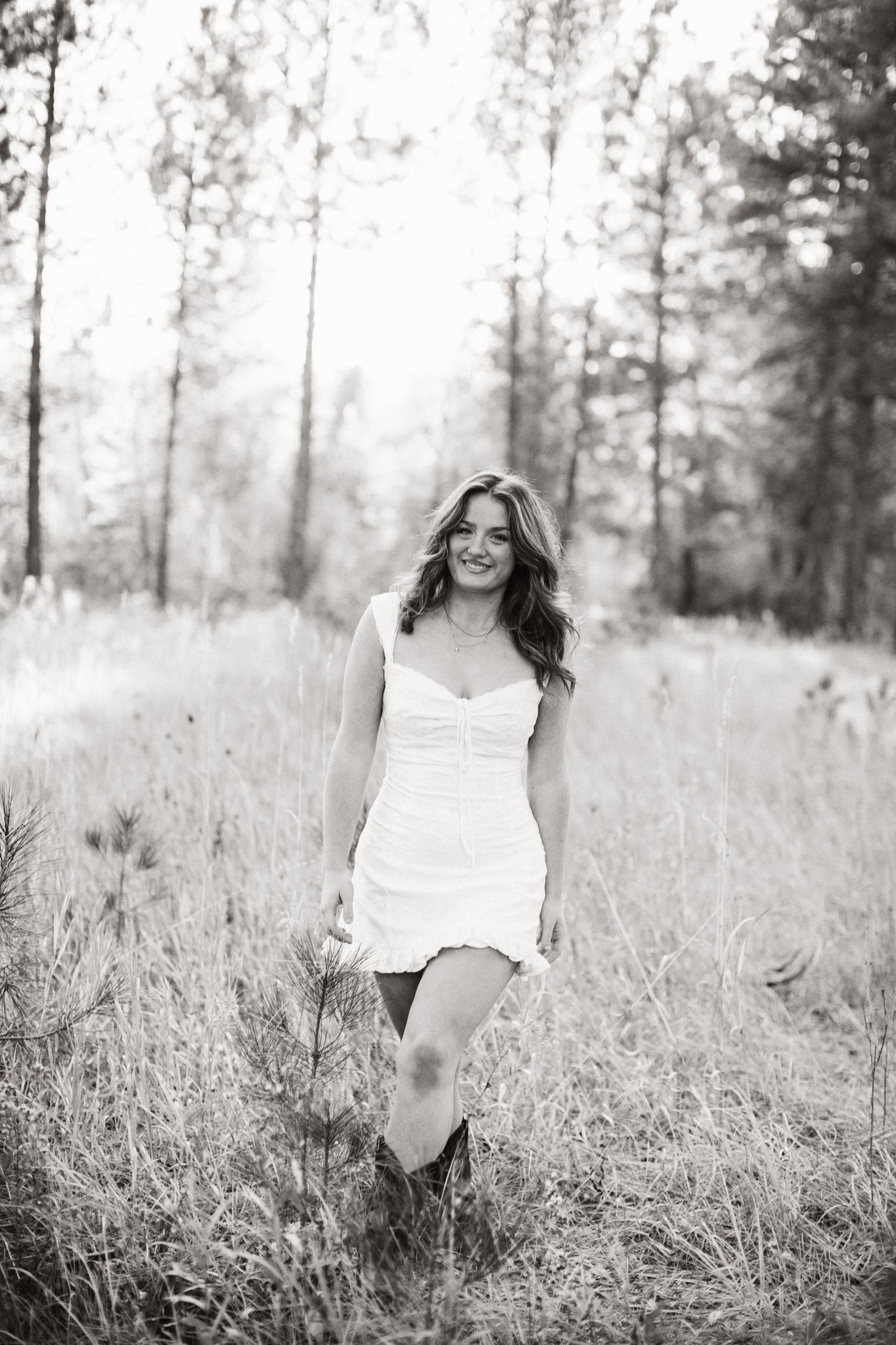 Black and white candid image of a young woman for her senior portraits near Boise
