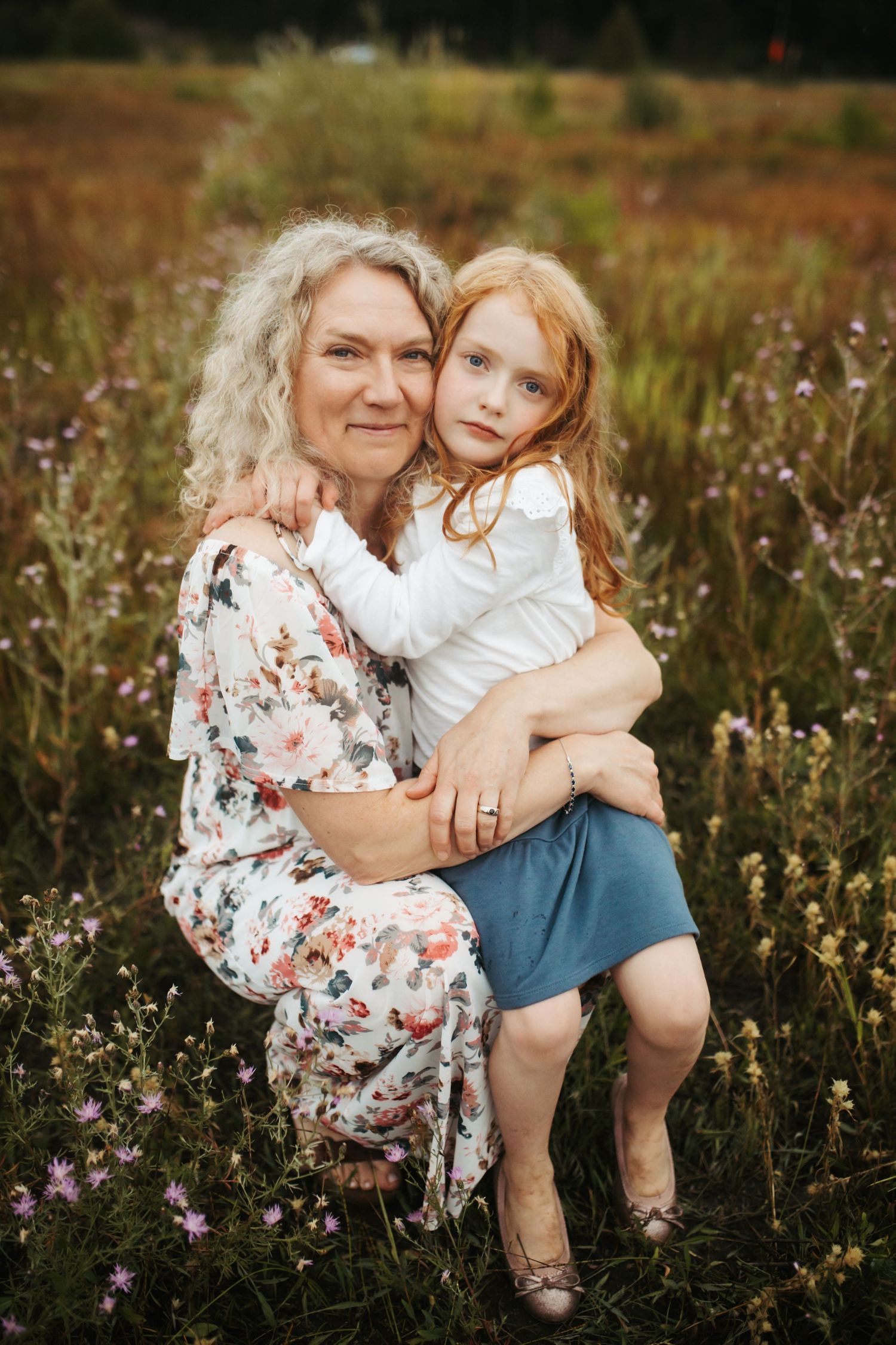 mom posing with her young daughter in a field at cascade Idaho