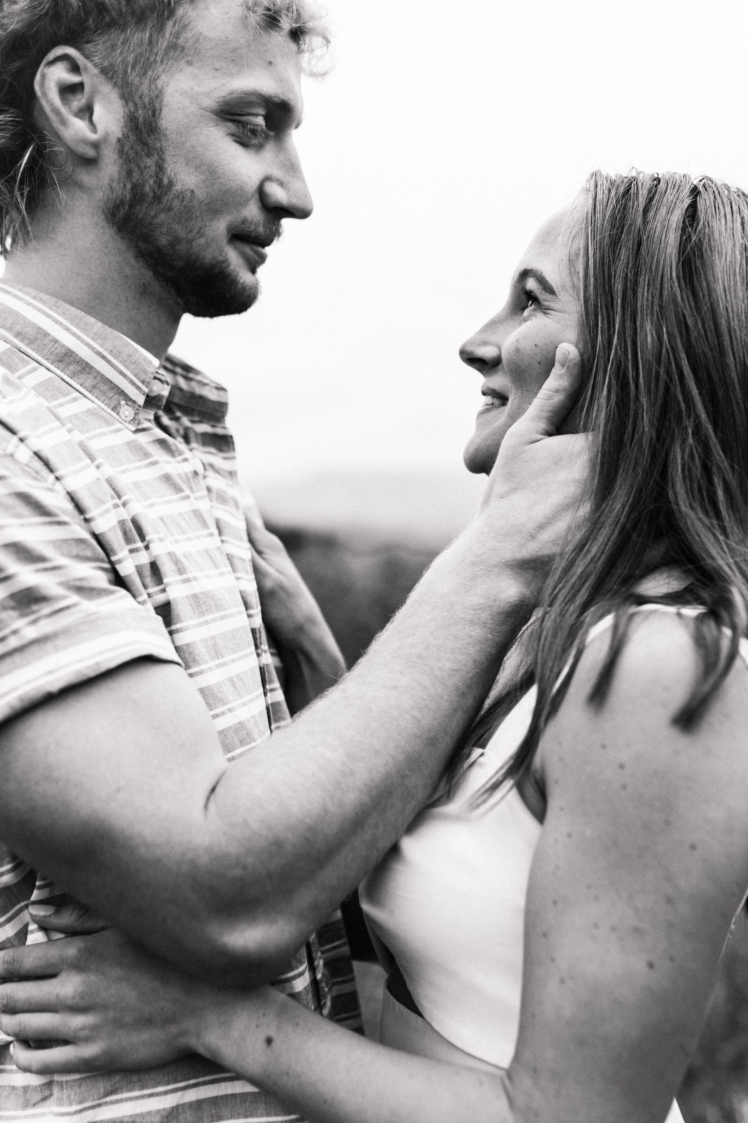 Husband looking down at his wife lovingly for a photoshoot