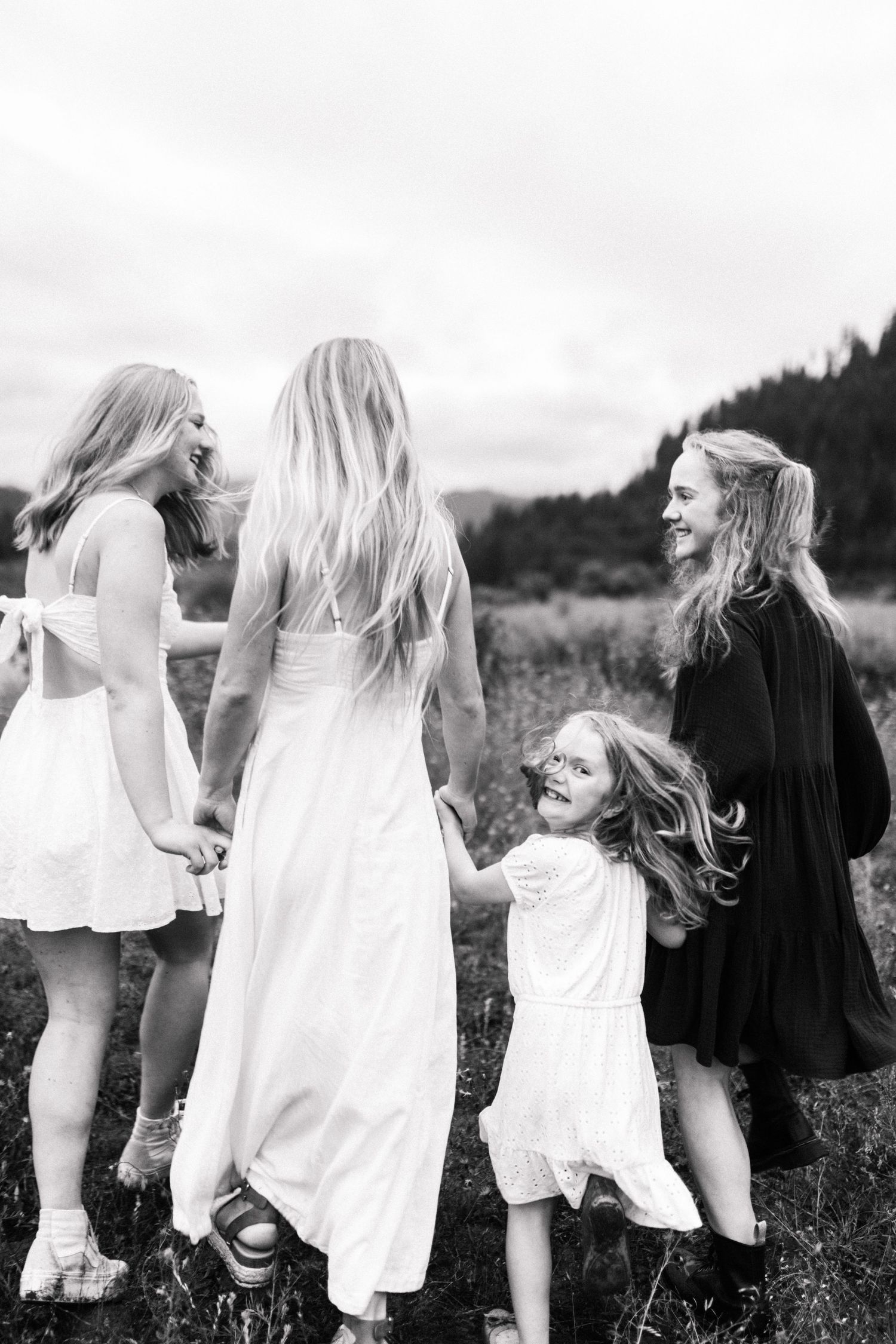 Sisters running together in a field at Cascade Idaho