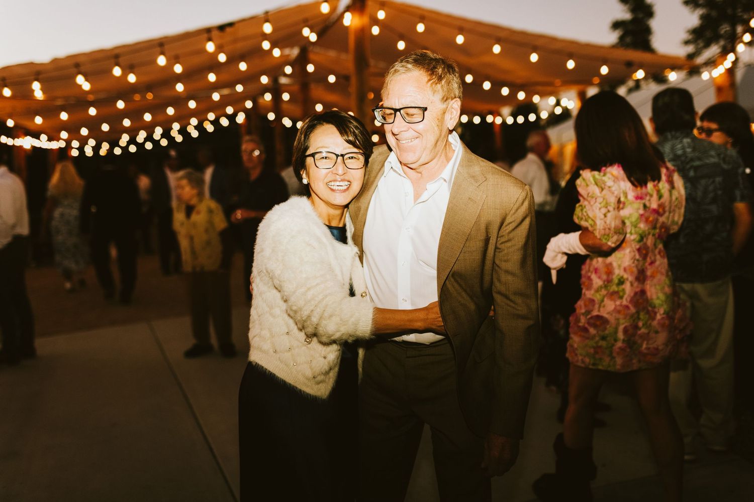 Guests smiling together for a photo at wedding reception