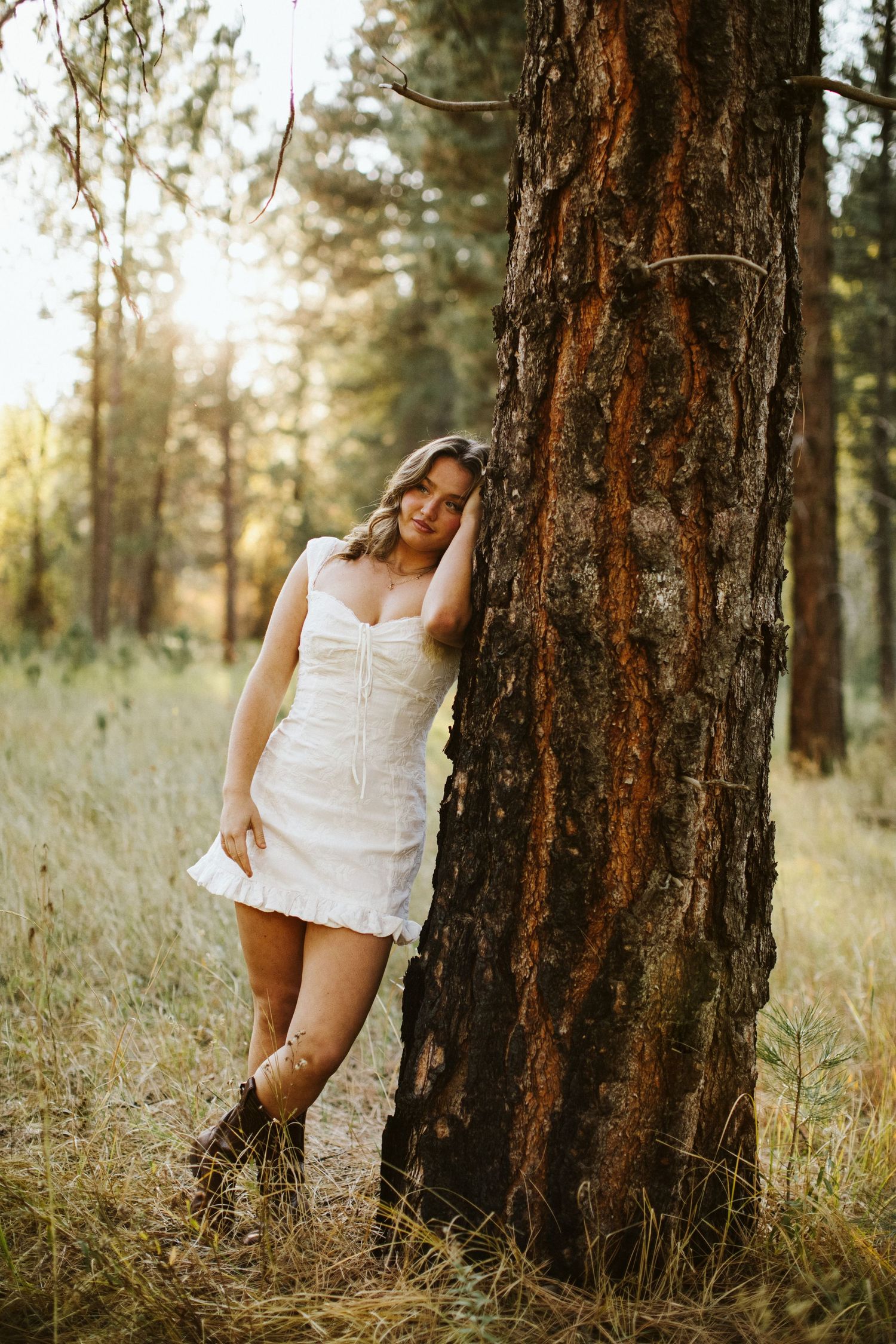 Young woman posing for her senior portraits at Robie Creek near Boise Idaho