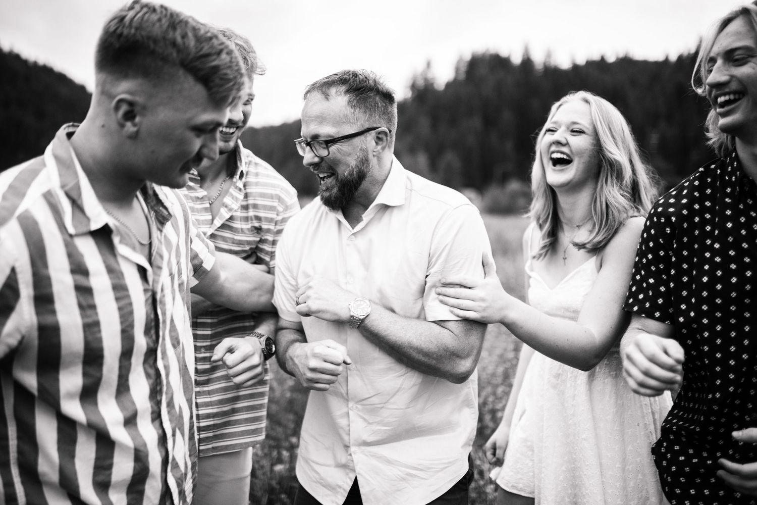 A black and white candid photo of dad with his kids