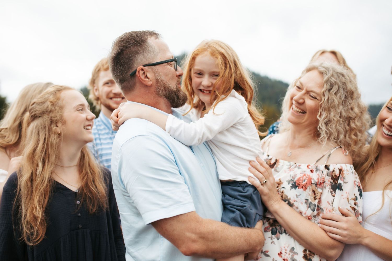 Dad holding his youngest daughter for family photos