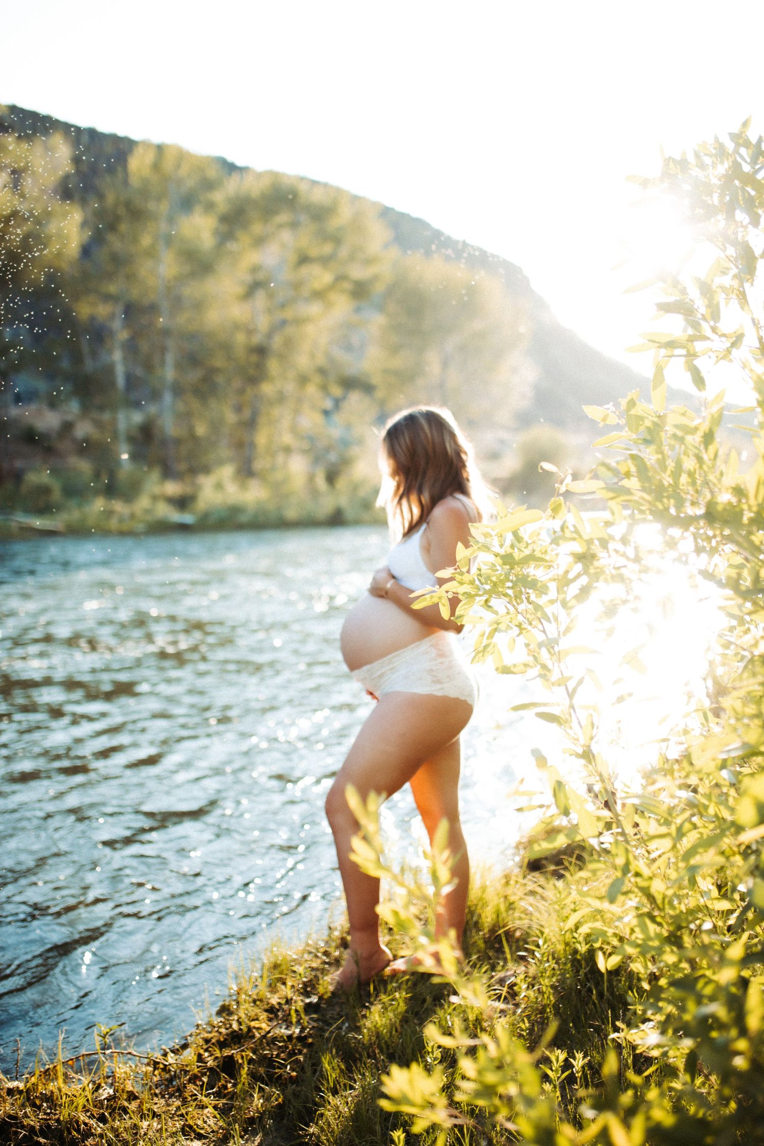 Artistic emotional image of a young woman for a maternity photoshoot along the Boise river
