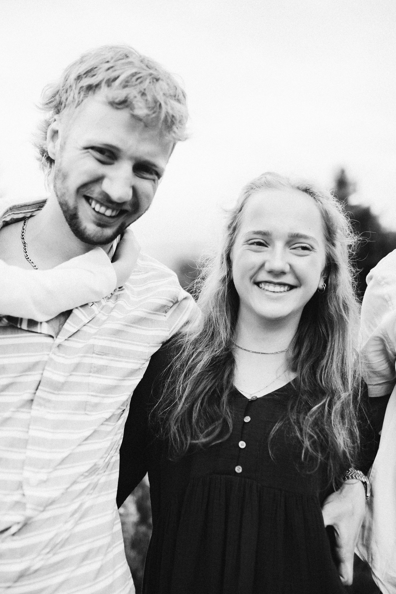Black and white candid image of siblings laughing together