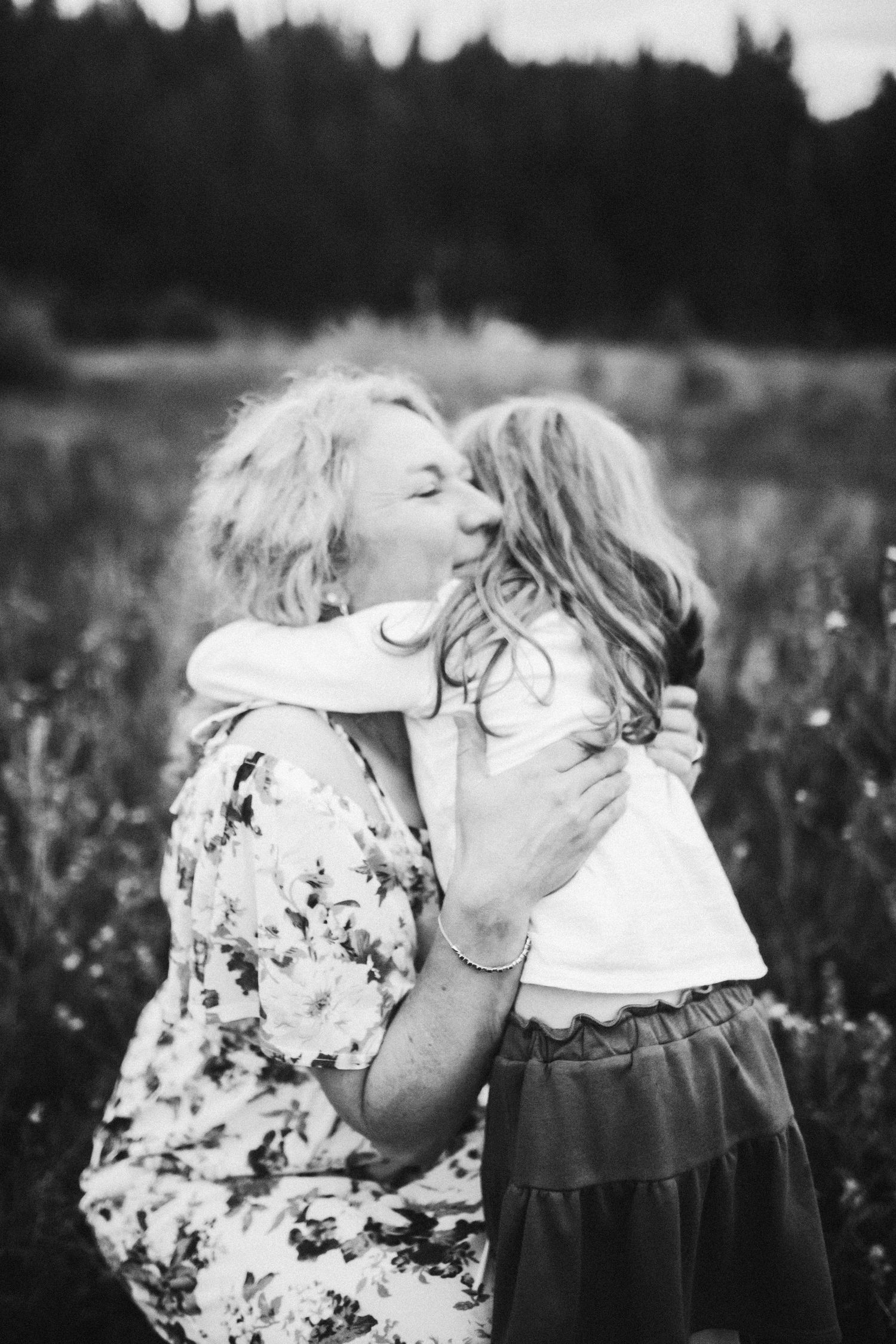 mom hugging daughter during family photoshoot