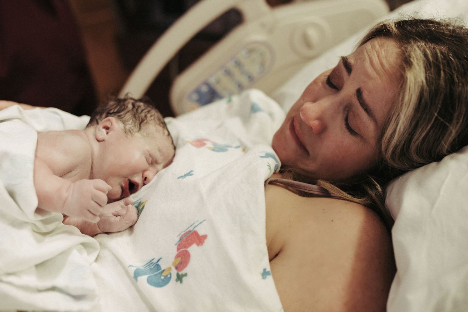 Birth photography of a mom holding her newborn in Boise