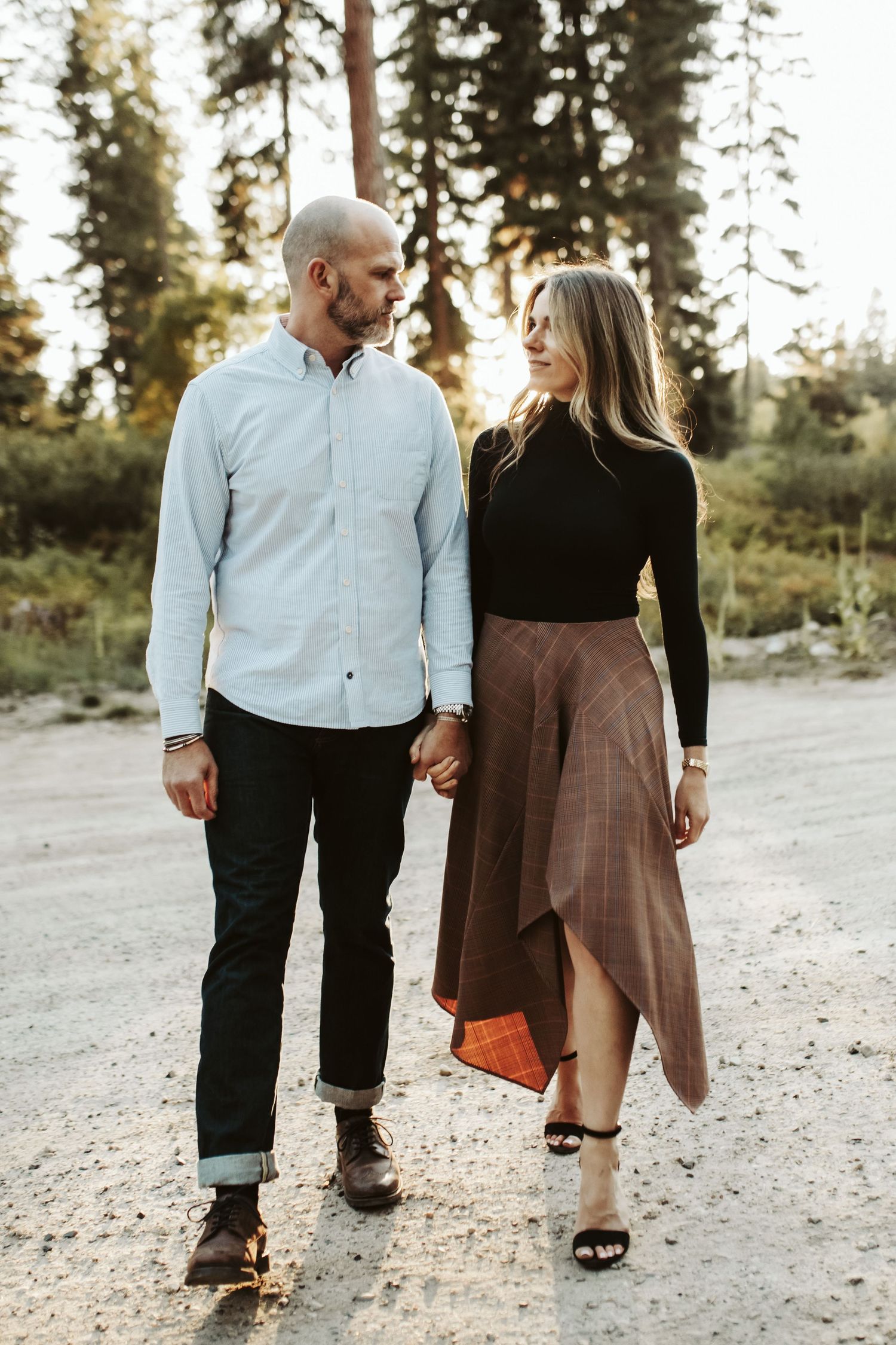 Husband and wife walking together during family photos in McCall