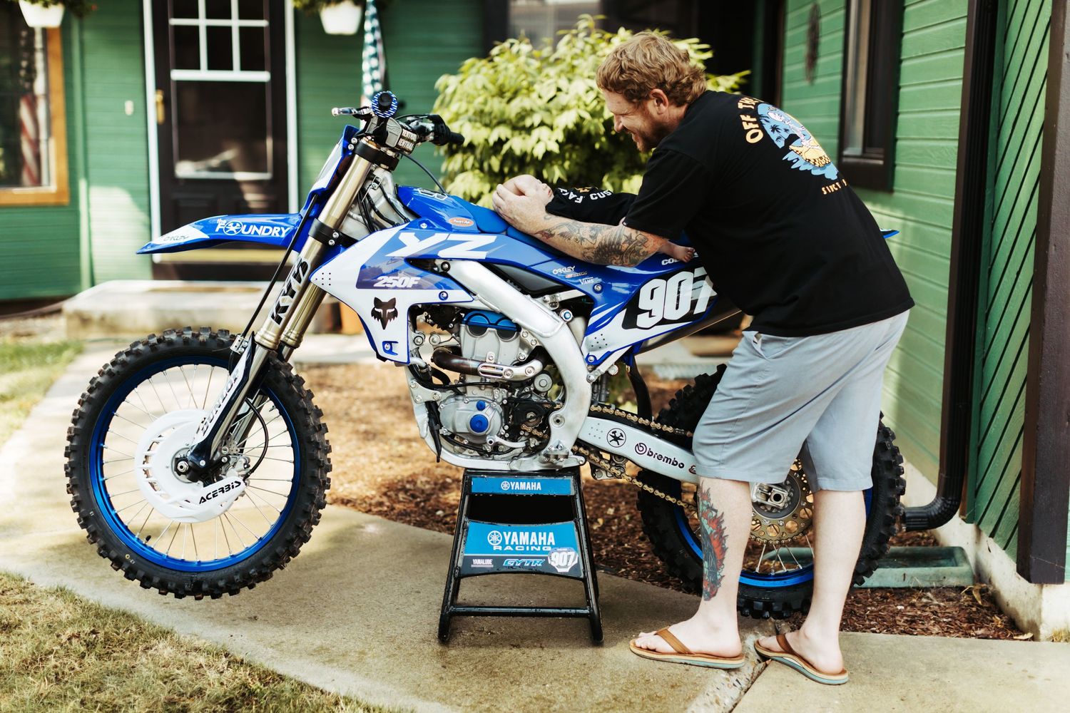 Dad with his newborn working on his motorcycle in Boise