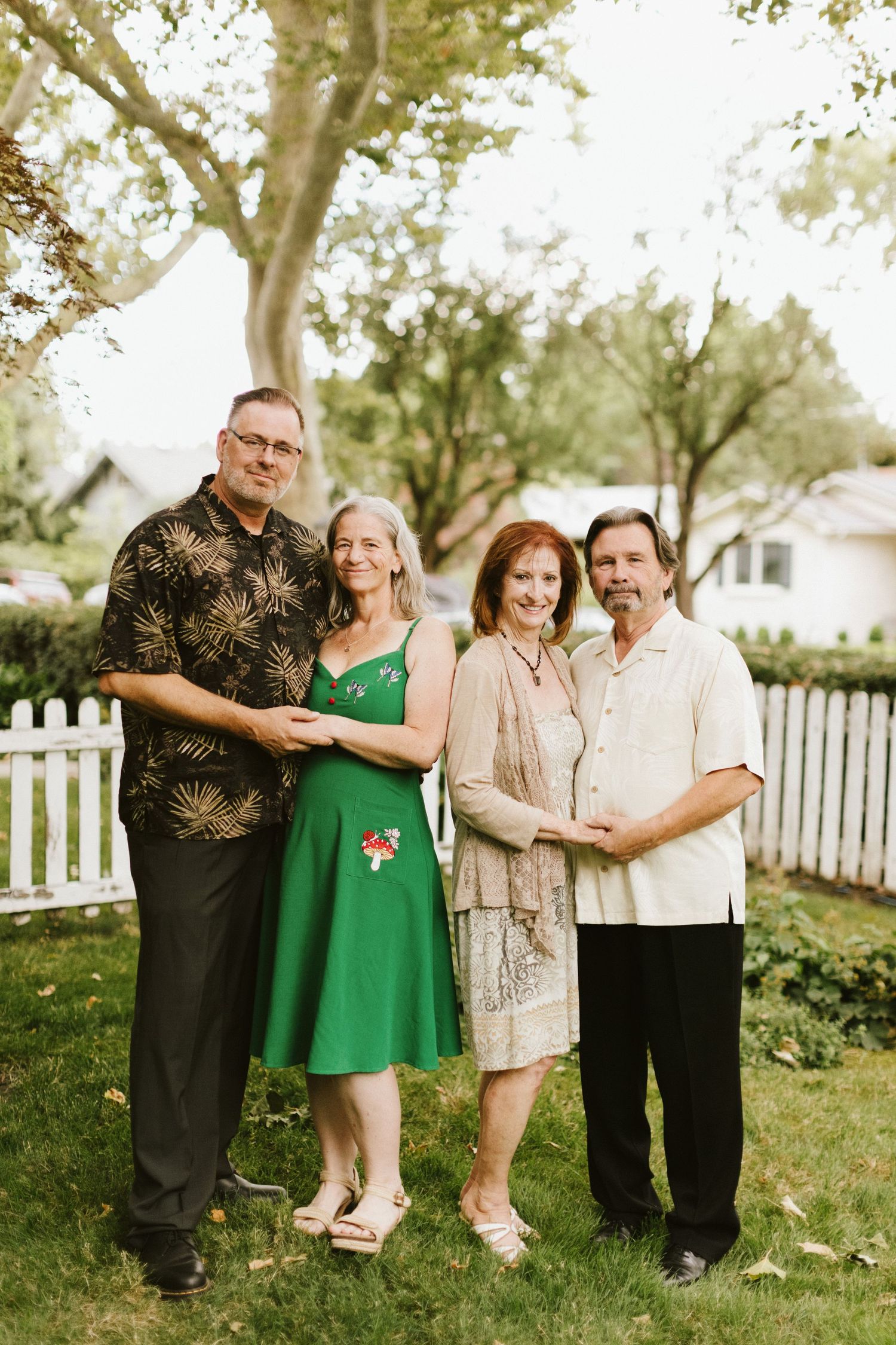 Two couples posing closely together during a family photoshoot in the Boise North End