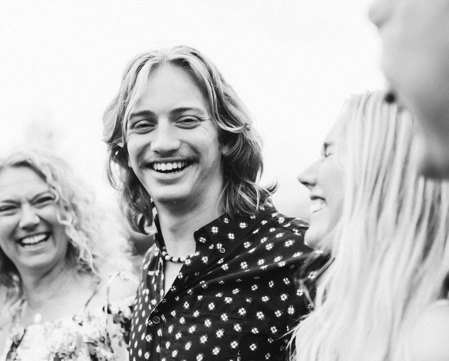 Black and white candid image of siblings laughing together