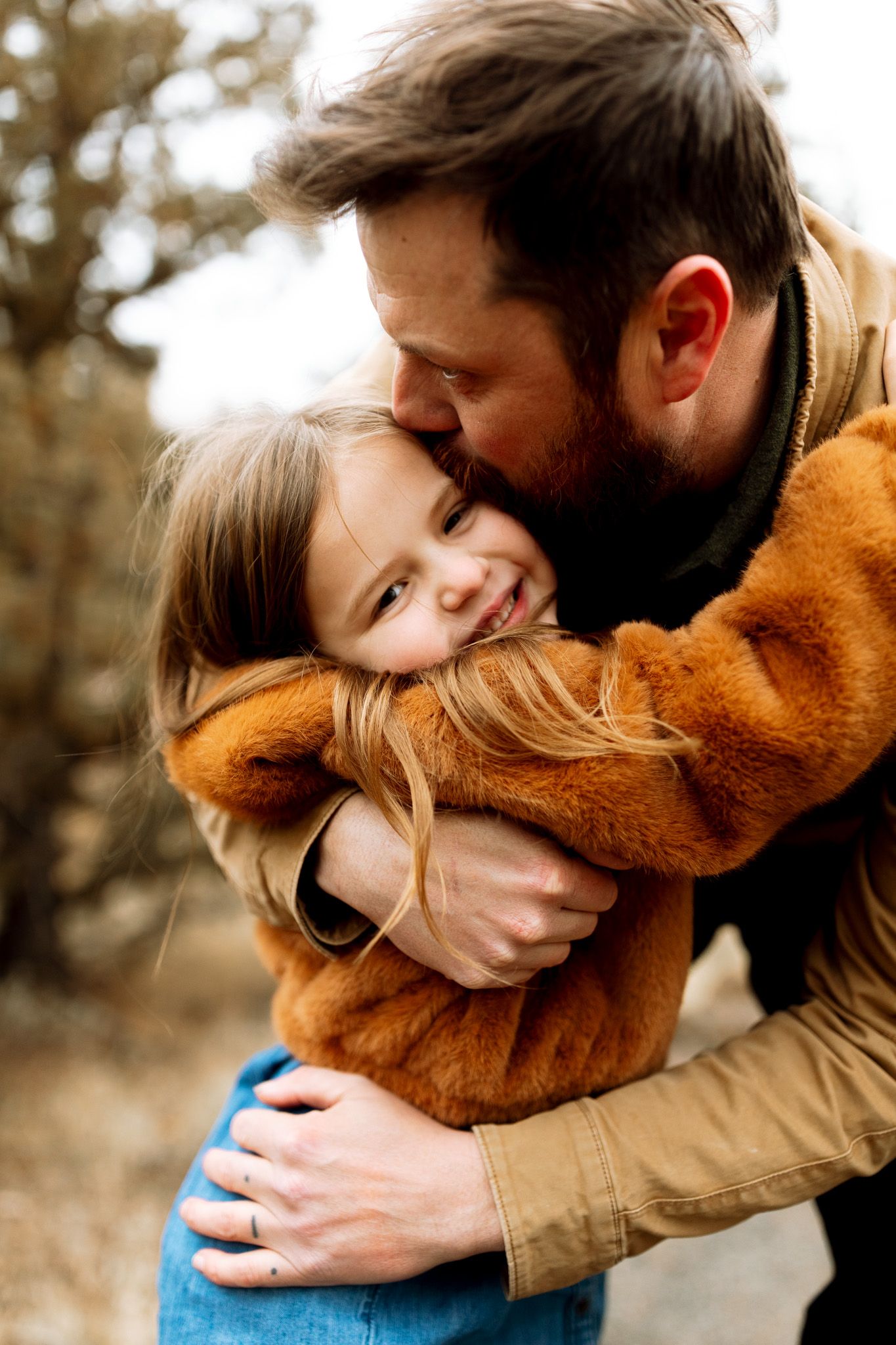 Father hugging his daughter during family photos