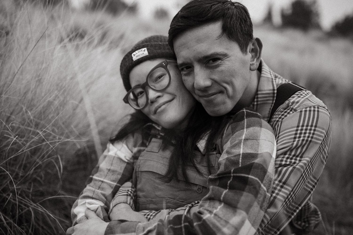 Couple sitting & smiling together closely for a photoshoot in Redmond Oregon