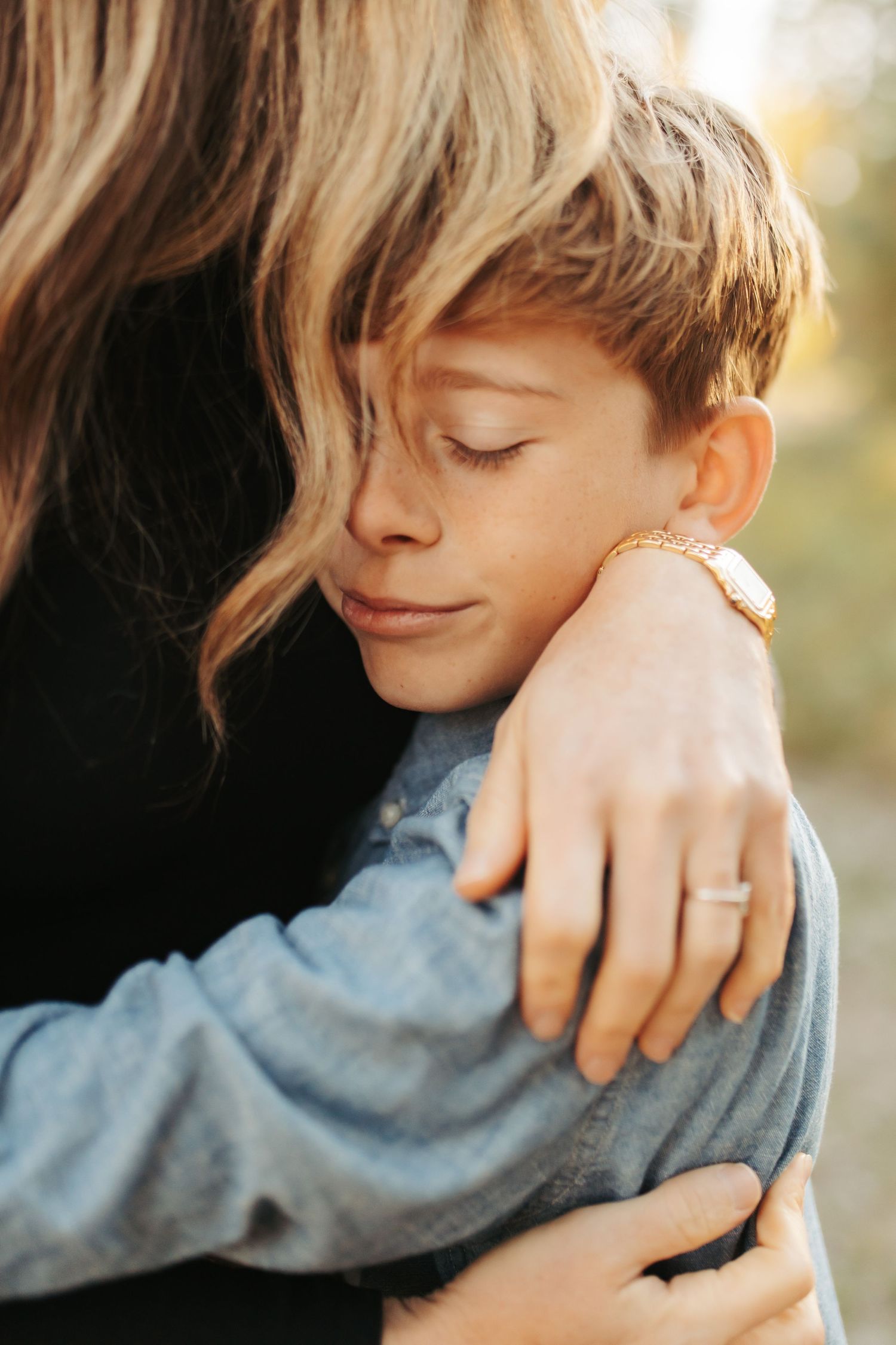 Candid photograph of son hugging his mom in McCall