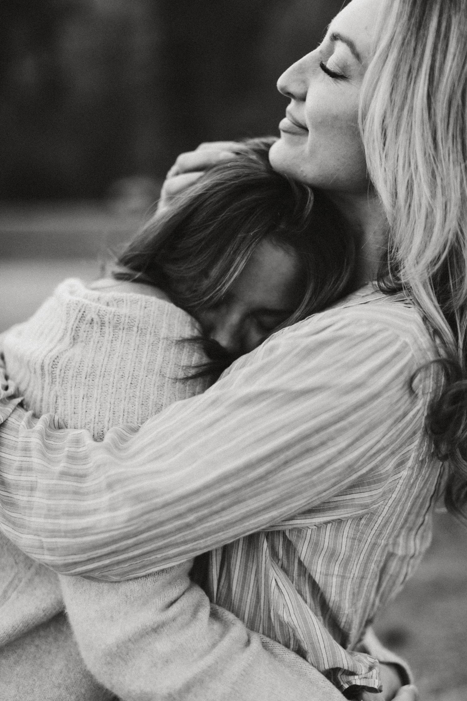 photograph of mother holding onto her daughter during her senior photoshoot