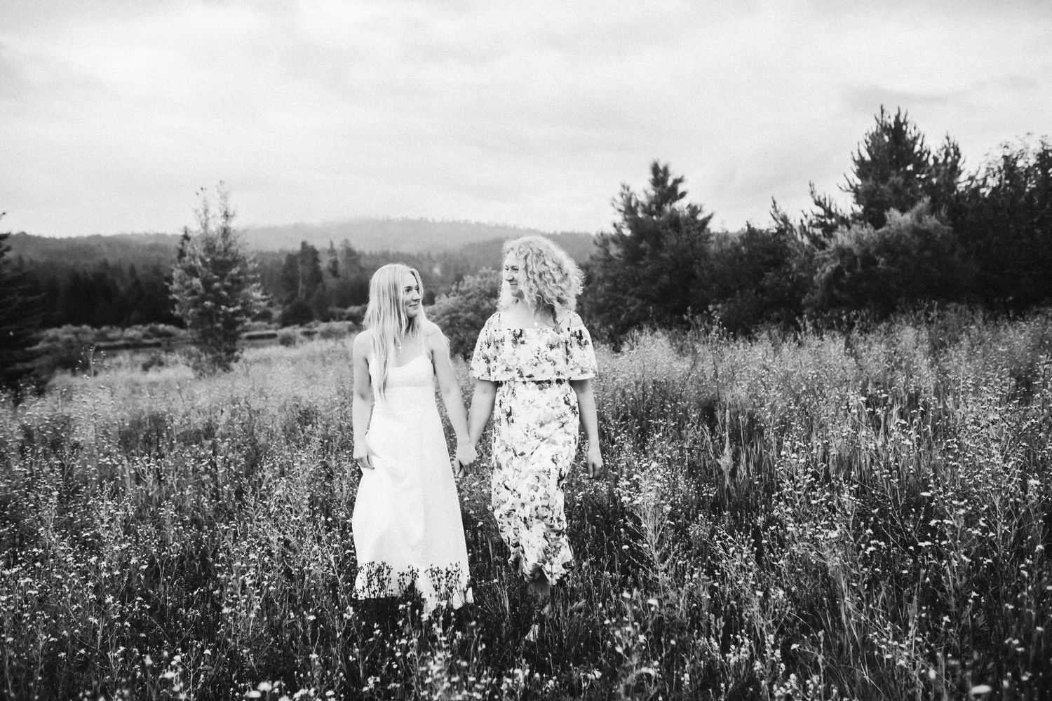 Mom walking with another eldest daughter for photos in cascade Idaho