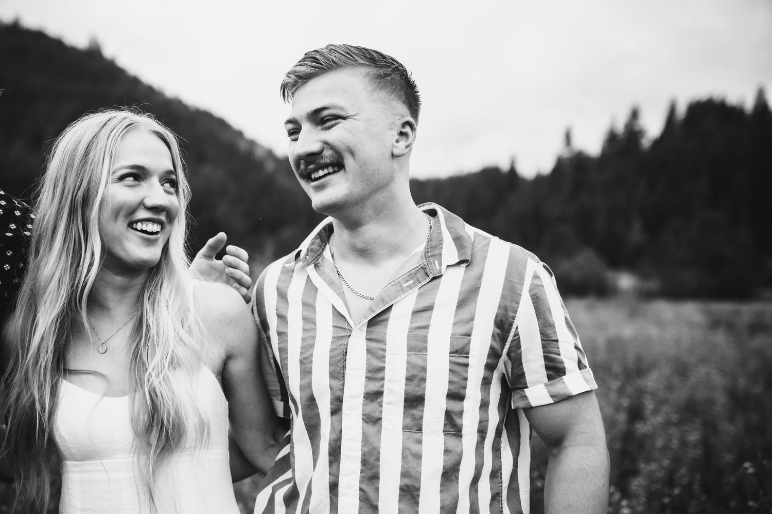 Black and white candid image of siblings laughing together