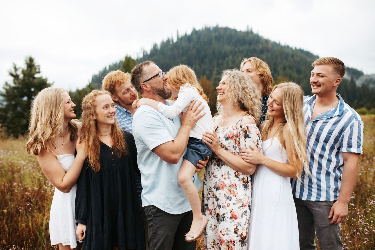 Dad holding his youngest daughter for family photos