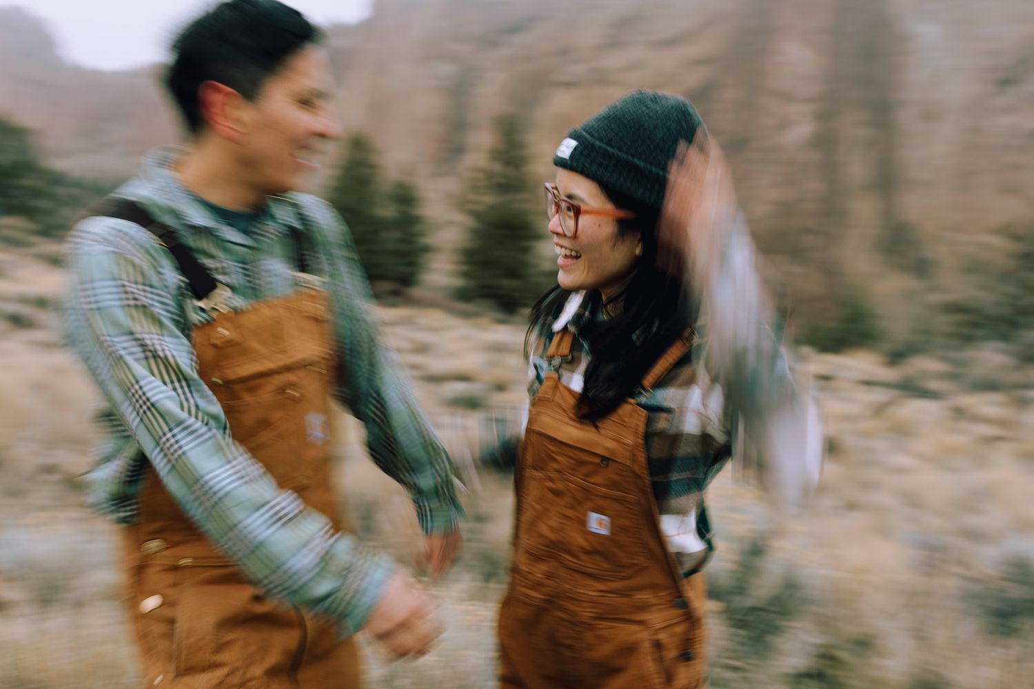 Couple holding hands running together for a couples session in Redmond Oregon