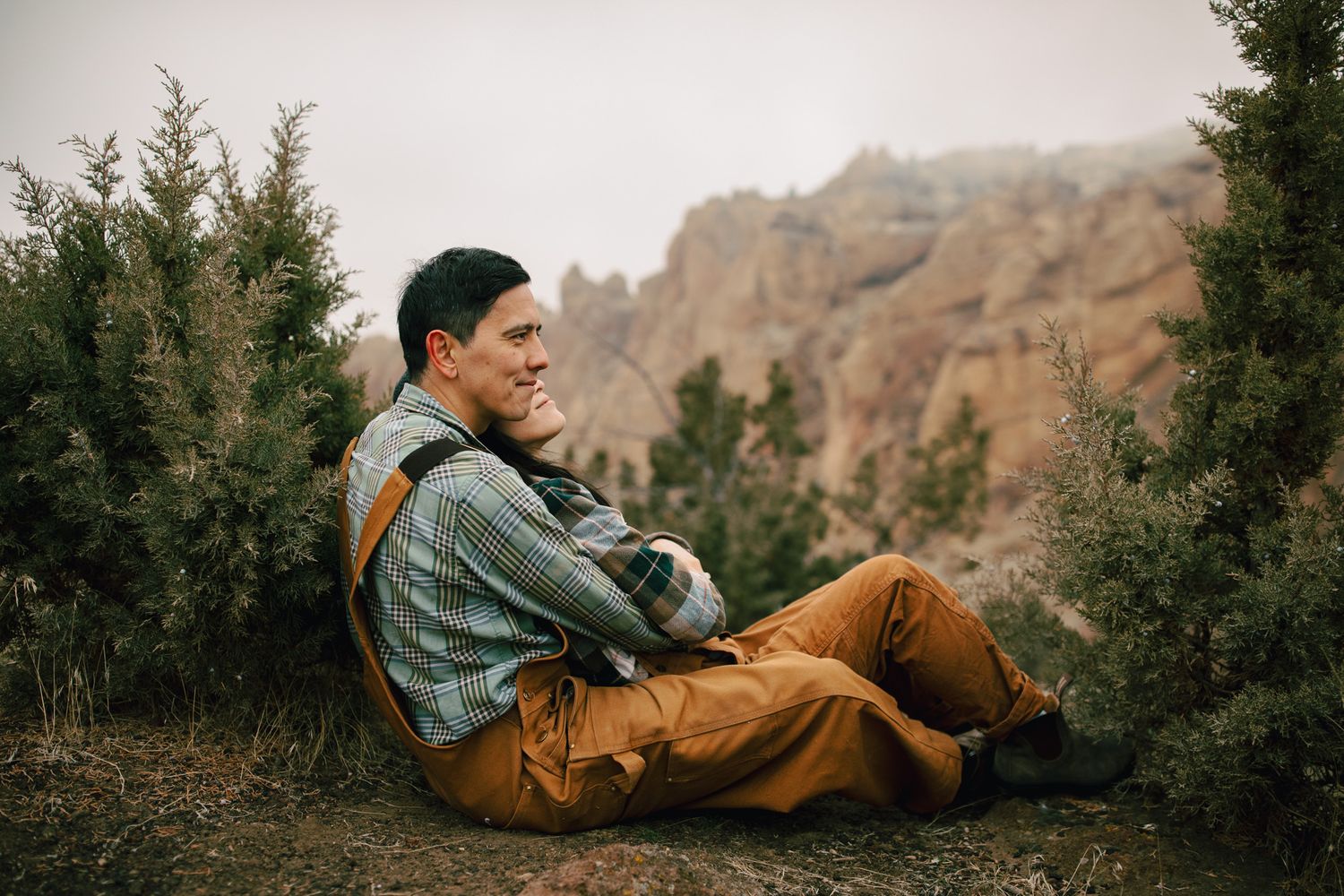 Couple snuggling closely for a photoshoot near Smith Rock Oregon