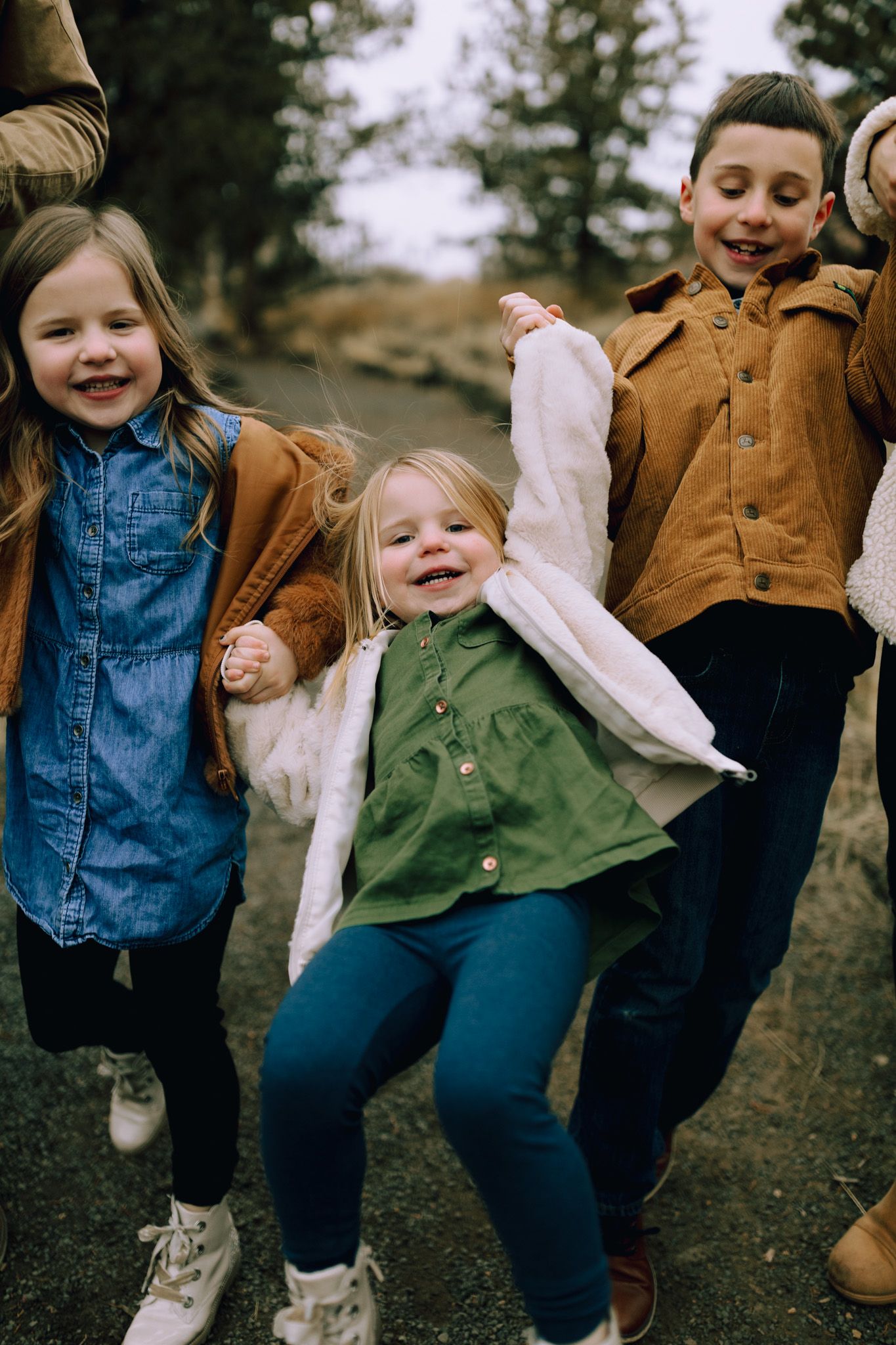 children laughing during family photoshoot in Redmond Oregon