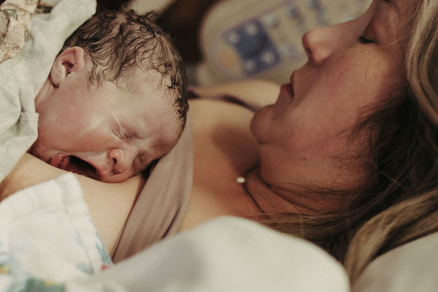 Birth photography of a mom holding her newborn in Boise