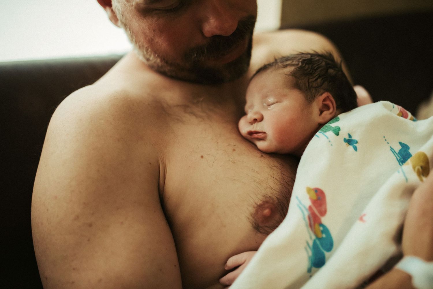 Photograph of a father and his newborn child in Boise Idaho