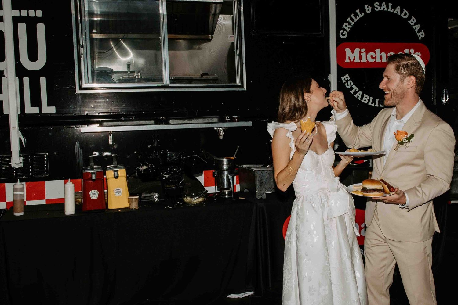 A couple dancing and celebrating at what appears to be a wedding reception or party.