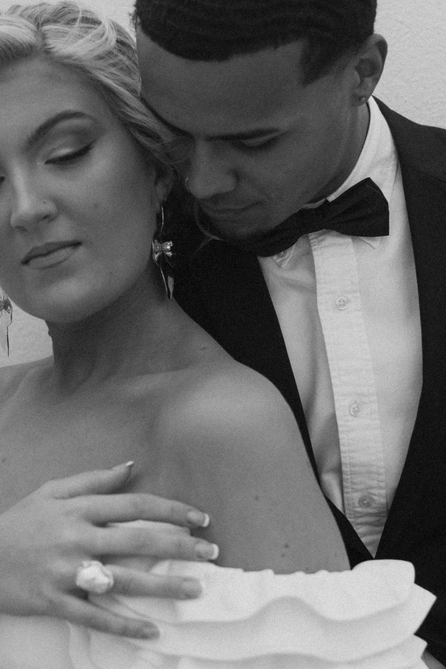 Intimate black and white wedding portraits showing tender moments between newlyweds.